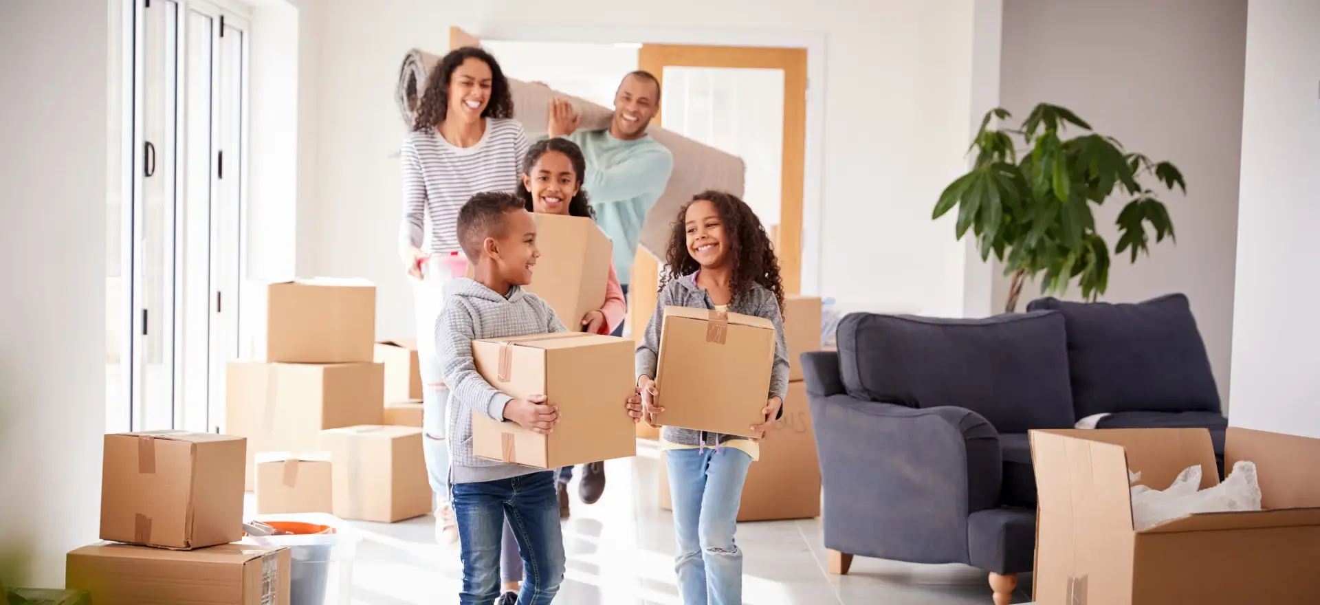 Happy family moving in to their new home thanks to Xpert Home Lending, Inc.